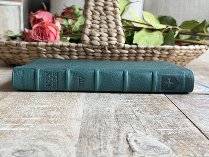 Turquoise Minerva Box NIV Thinline Reference (Premier Collection) by Rock Wall Bibles, spine at an angle